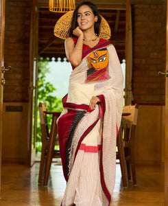 White cotton saree with bold red-black borders, featuring a hand-painted Durga motif