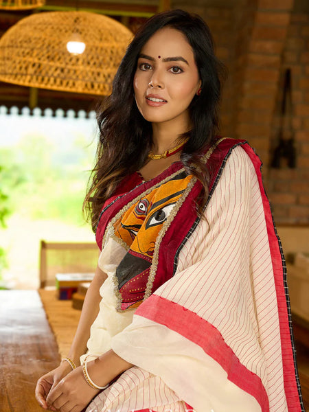 White cotton saree with bold red-black borders, featuring a hand-painted Durga motif