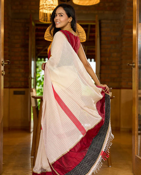 White cotton saree with bold red-black borders, featuring a hand-painted Durga motif