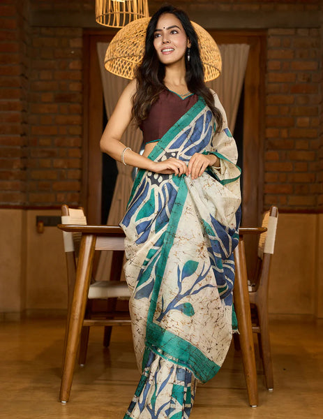 Classic Ivory pure silk saree highlighted by teal borders and hand batik artistry