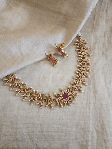 Aarvi goldplated contemporary Necklace set with Green and Red Stonework