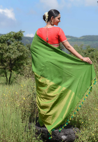 Elegant green and gold half-and-half saree with Gota patti lace