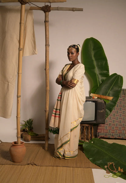 Off white handwoven mul cotton saree with green and zari border