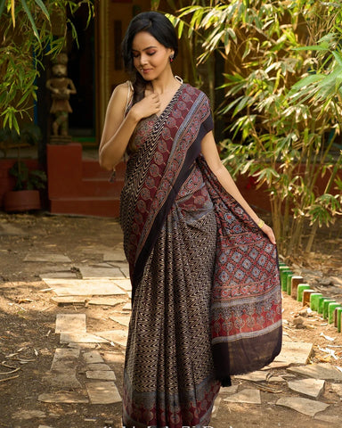BLACK HAND BLOCK PRINTED AJRAKH MODAL SAREE WITH ZIGZAG PATTERN AND ORNATE BORDER