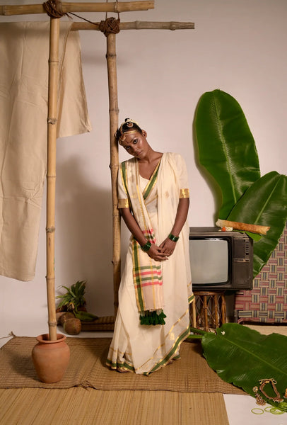 Off white handwoven mul cotton saree with green and zari border