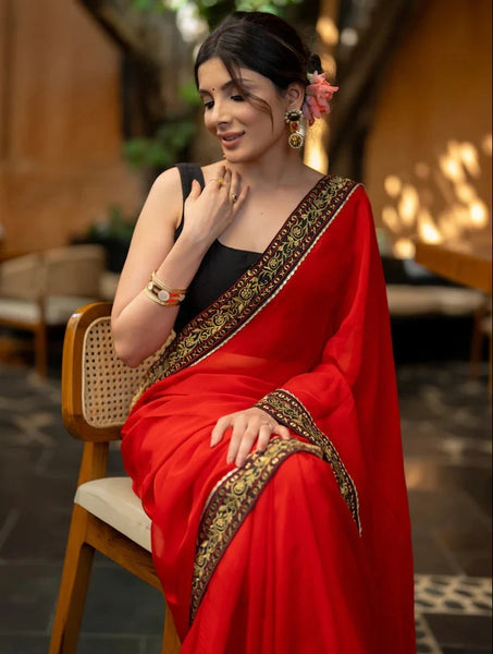 RED ORGANZA SAREE HIGHLIGHTED WITH BEAUTIFUL EMBROIDERED BORDER.
