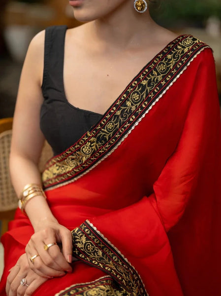 RED ORGANZA SAREE HIGHLIGHTED WITH BEAUTIFUL EMBROIDERED BORDER.