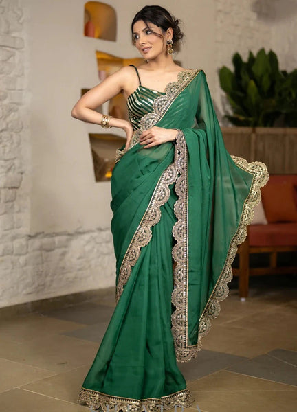 BOTTLE GREEN ORGANZA SAREE HIGHLIGHTED WITH MATCHING SCALLOPED LACE