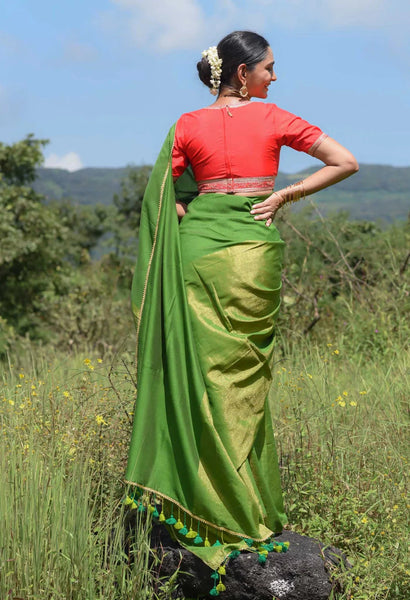 Elegant green and gold half-and-half saree with Gota patti lace