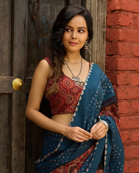 FUSION OF AJRAKH CHARM AND BANDHEJ FLAIR. RUST & TEAL COTTON SAREE