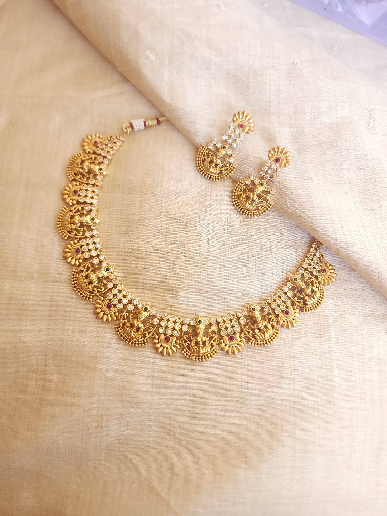 Aarvi goldplated contemporary Necklace set with Green and Red Stonework