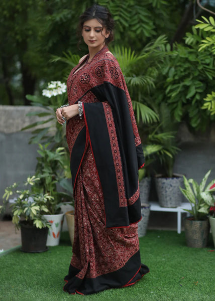 MAROON AJRAKH SAREE WITH BLACK BORDER & ACCENTUATED WITH STONE EMBELLISHMENT