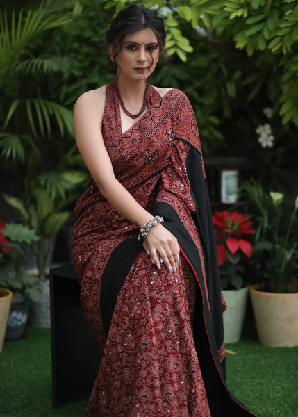 MAROON AJRAKH SAREE WITH BLACK BORDER & ACCENTUATED WITH STONE EMBELLISHMENT