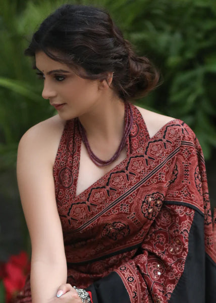 MAROON AJRAKH SAREE WITH BLACK BORDER & ACCENTUATED WITH STONE EMBELLISHMENT