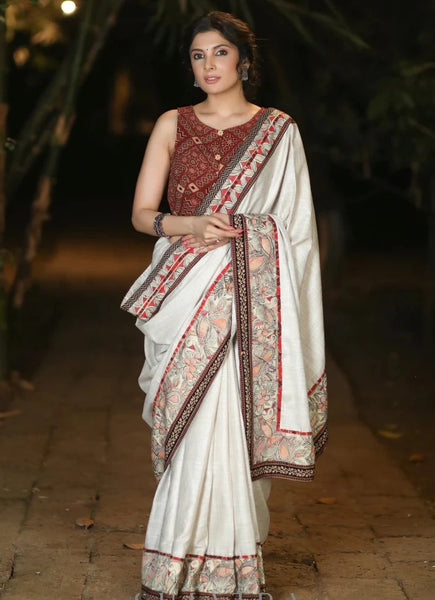 CREAM COTTON BLEND SAREE WITH HANDPAINTED MADHUBANI BORDER HIGHLIGHTED WITH AJRAKH DETAILING