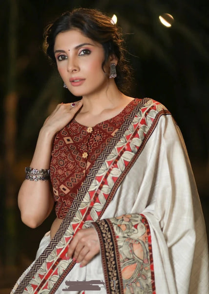 CREAM COTTON BLEND SAREE WITH HANDPAINTED MADHUBANI BORDER HIGHLIGHTED WITH AJRAKH DETAILING