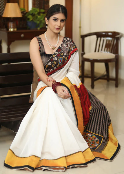 WHITE CHANDERI SAREE WITH EXCLUSIVE KALAMKARI HAND PAINTED BORDER AND MAROON PALLU WITH MIRROR WORK