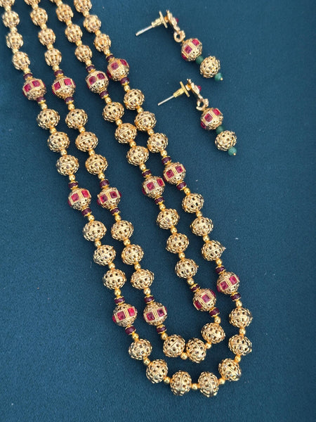 Long gold plated Matar Mala Necklace on Red