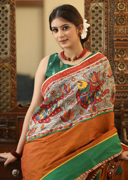 RUST COTTON SAREE WITH EXCLUSIVE HAND PAINTED MADHUBANI PALLU, LINE PLEATS & MIRROR WORK BORDER