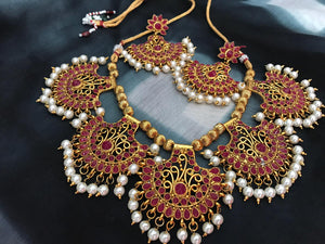 Red Stone Studded Pankhi Necklace Set With Metal Base & With Micron Gold Polish & Matching Earrings