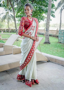 TISSUE LINEN SAREE WITH IKAT BORDER AND INTRICATE HAND EMBROIDERY