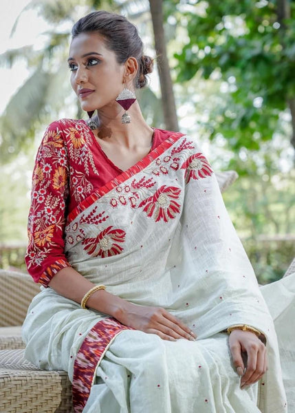 TISSUE LINEN SAREE WITH IKAT BORDER AND INTRICATE HAND EMBROIDERY